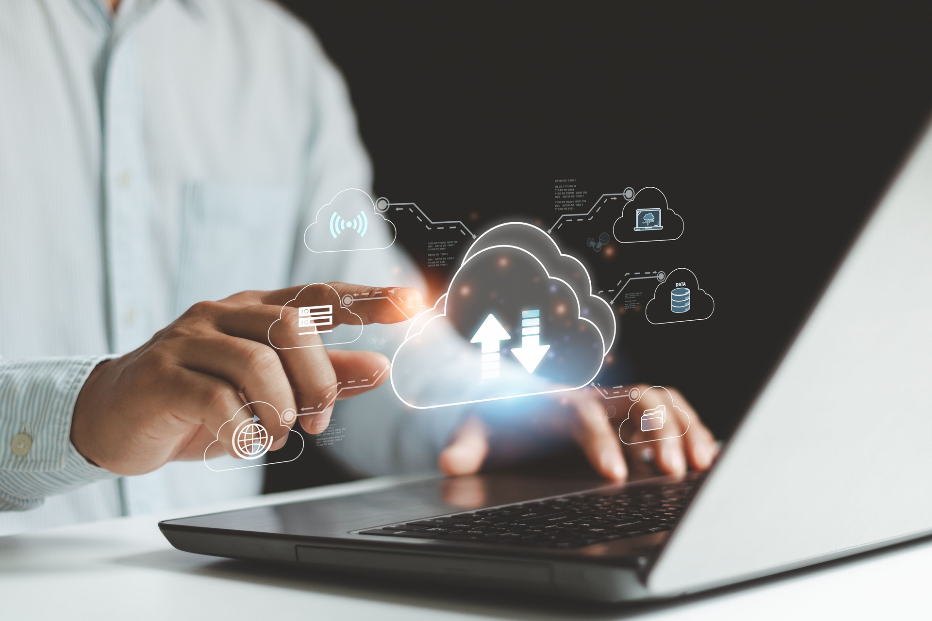 Businessman use laptop computer and hand pointing on virtual cloud computing diagram. Cloud technology. Data storage. Networking and Internet service concept. Administrator, IT support, Helpdesk.