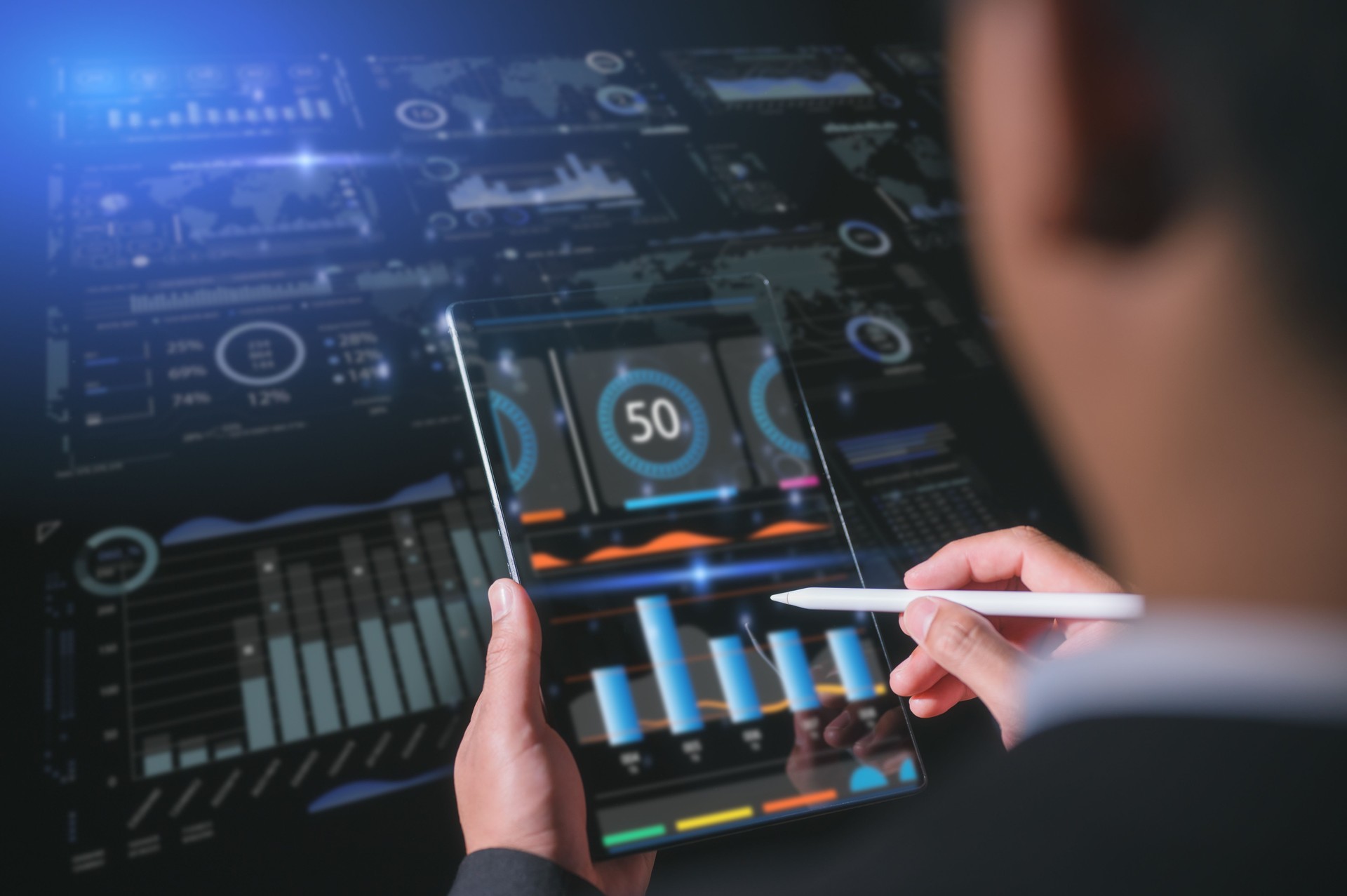 Businessman using tablet with stylus pen, DevOps concept, software development, IT operations, agile programming, data business analysis and Data Management System with KPI and metrics